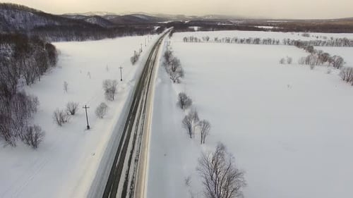 Car Travels Road Through Snowy Winter Landscape