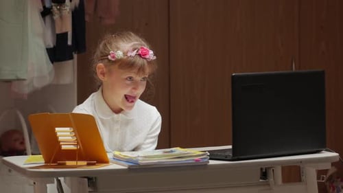 Girl Studying Online with Laptop at Home
