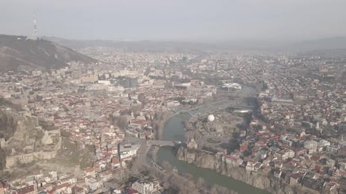 Aerial view of Metekhi church in old Tbilisi located on cliff near river Kura. Georgia 2021 winter
