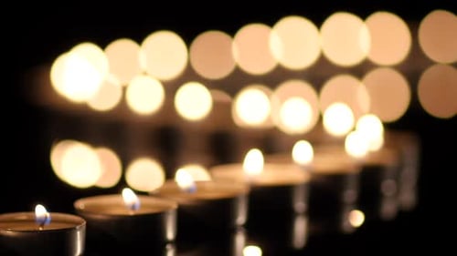 Many Candles Light on Black Background