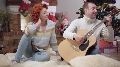 Happy Couple Sings Together During Christmas Holiday