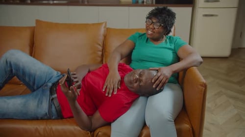 Couple Relaxing on Couch Together in Home