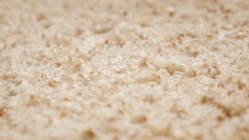 Fresh shallow DOF slow tilt over bread ready for toasting close-up 4K 2160p 30fps UltraHD footage -