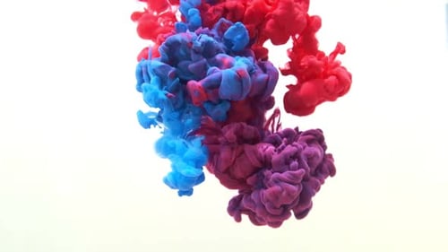 Red and Blue Ink in Water Mixed Close Up
