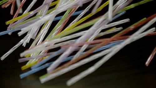 Colorful Plastic Straws Falling in Slow Motion