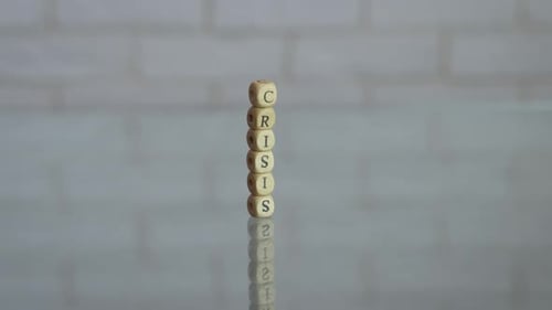 Crisis Spelled Vertically With Blocks Reflective Surface