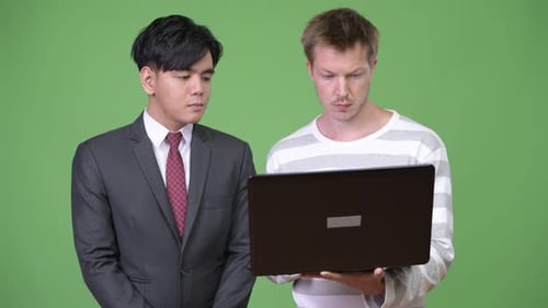 Two Young Men Looking at a Laptop Together