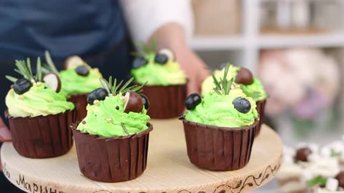 Iced Cupcakes Displayed on a Wooden Stand