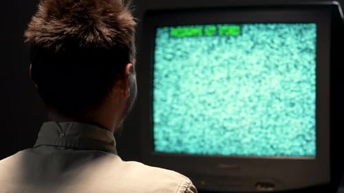 Young Man Watches Static On Old Television