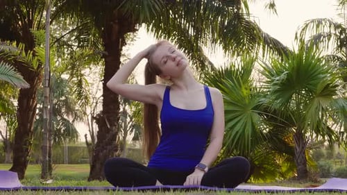 Fitness Woman Stretching Body Tilts Head to Side Stretch Neck on Yoga Mat