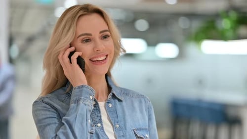 Woman Talking on Cell Phone in Office