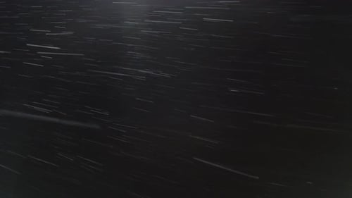Real snow on a black background, shot on the street
