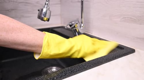 Close Up of Person Cleaning Kitchen Sink