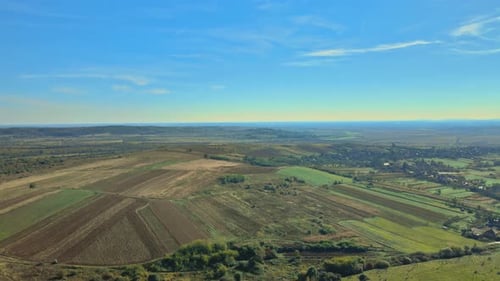 Aerial View Agricultural Field on Hillside in Mountains Near Village