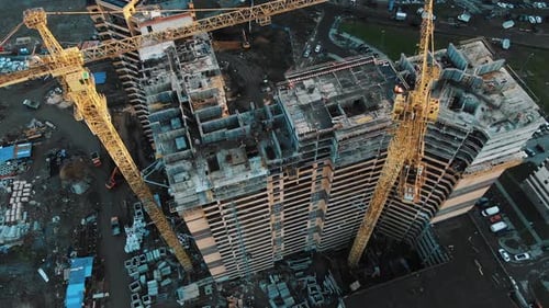 Yellow Construction Cranes Above Skyscrapers Aerial Motion