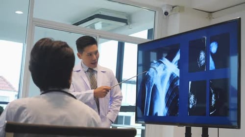 Doctor Presenting X-Rays in Modern Office Setting