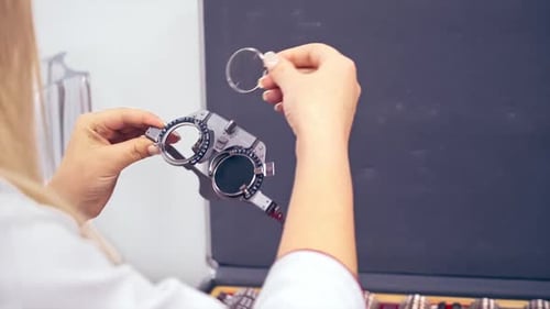 Ophthalmology eyesight diagnostic. Optometrist holding messbrille in ophthalmology clinic