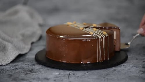 Chocolate Cake Slice Being Removed with Server
