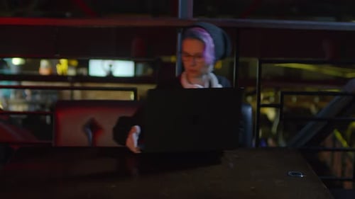 Female Programmer Using Computer in Bar