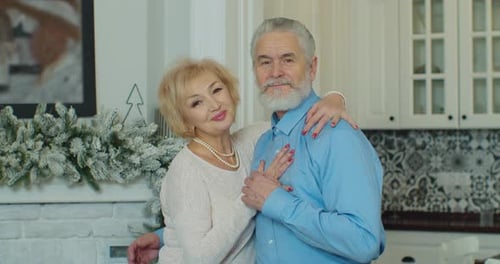 Senior Couple Embracing at Home at Christmas