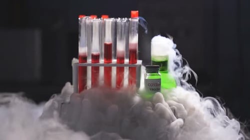 Test Tubes and Green Vaccine with Fog
