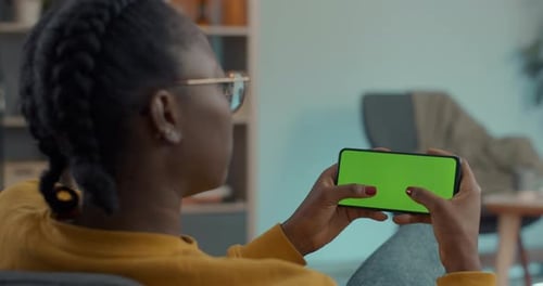 African American Woman Texting on Green Screen of Smartphone