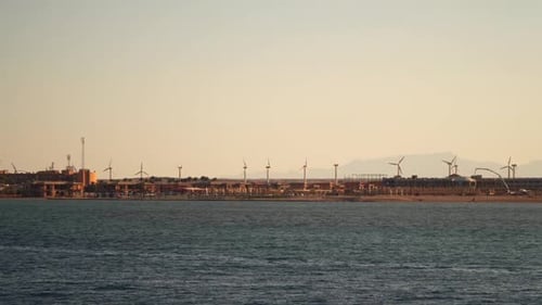 Wind turbines on the coast. View from the sea from the ship