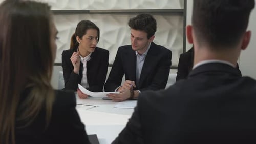 Man and woman discussing at a meeting