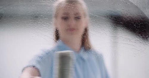 Cleaning - Woman Cleaning Window with Detergents