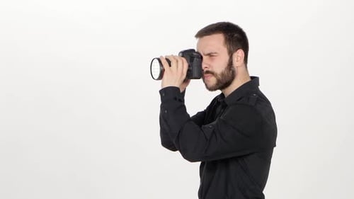 Young Adult Photographer Using DSLR Camera in Studio