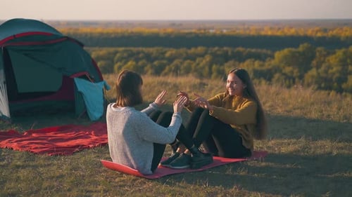 Young Women Exercising Outdoors While Camping