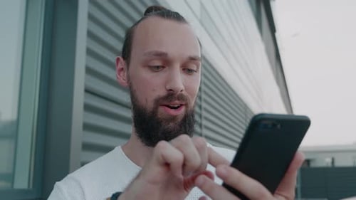 Man Using Smart Phone Outdoors in Urban Setting