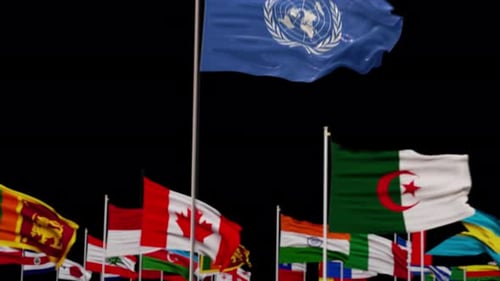Rising United Nations Flag Waving with World Flags Background