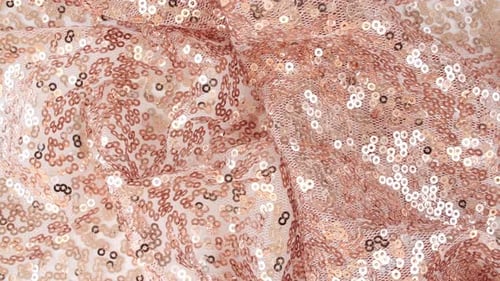 Tissu rose doré à paillettes