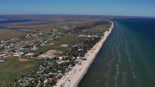 Beautiful flight in summer over the beach. People are resting near the sea.