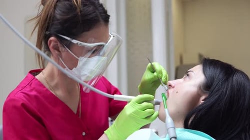 Dentist Examining a Patient's Teeth at the Clinic