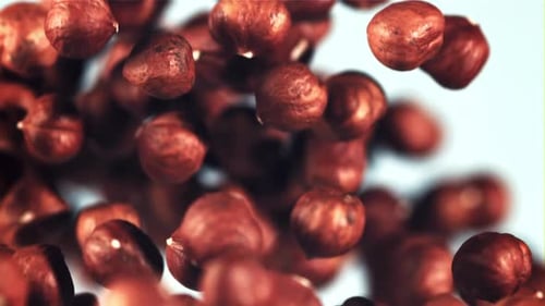 Peeled Hazelnuts Rise Up and Rotate in Flight