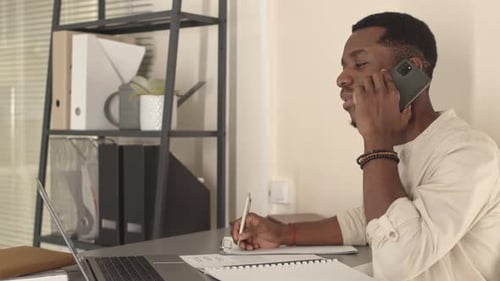 Man Talking on Smartphone in Office