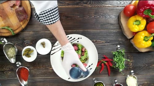 Chef Prepares Beef Salad with Fresh Ingredients