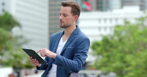 Man Using Tablet in Urban Setting