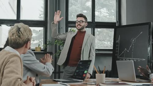 Business Team Celebrates Success in Modern Office