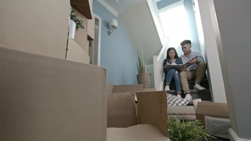 Couple Planning Move Surrounded by Boxes