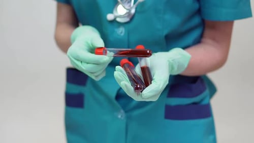 Medical Professional Holding Blood Sample Test Tubes