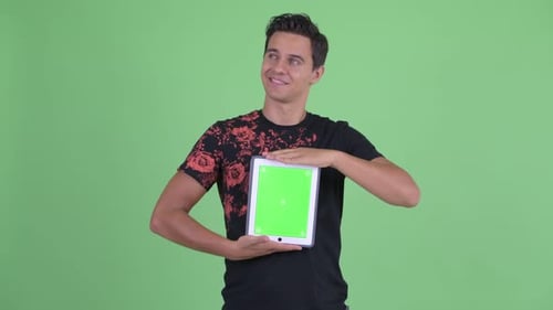 Young Man Holding Tablet with Green Screen