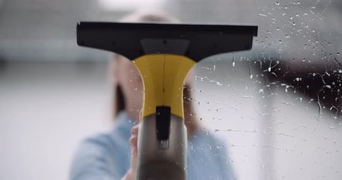 Cleaning - Woman Cleaning Window with Detergents