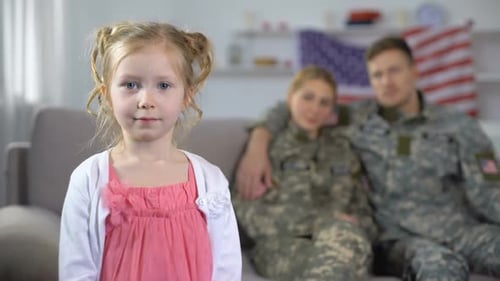 Child With Military Parents and American Flag