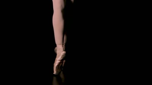 Elegant Ballerina Dancing on Pointe, Black Background