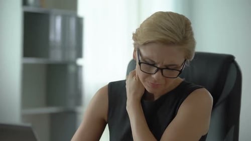 Middle-Aged Office Worker Suffering From Neck Pain, Working on Laptop, Health