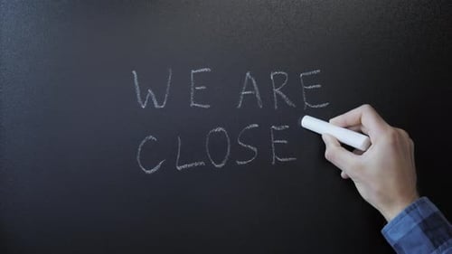 Hand writing We are closed on chalkboard