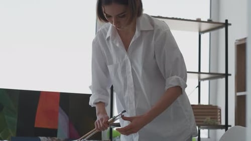 Young Artist Preparing to Paint in Studio